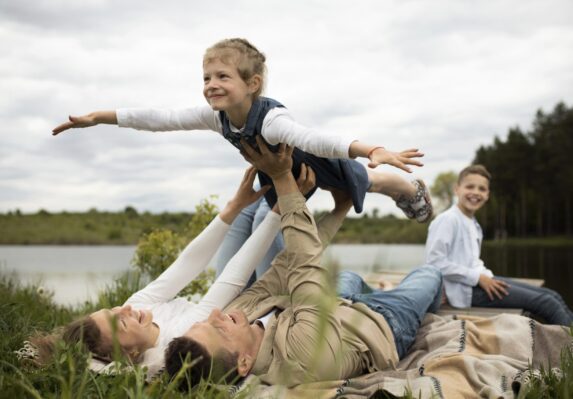 Family enjoying a playful outdoor moment. Cash Flow Management To Make Dreams Happen.